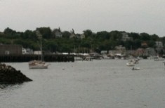 Yachts take up the mooring field but work boats predominate along the piers that line Gloucester Harbor.