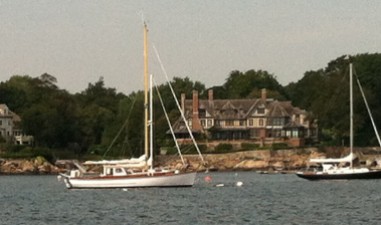Gorgeous homes line a snug harbor filled with classic yachts at Manchester-by-the-Sea, MA.