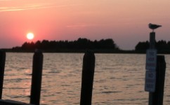 Visitors to Crisfield enjoy the sunset over Tangier Sound, regardless of regulations posted on the town pier.